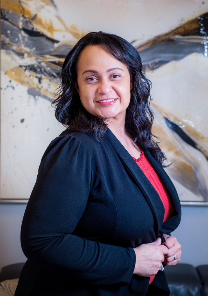 Therapist Sara Betancourt LAMFT smiling in a professional setting, offering mental health services for adults and couples, with a focus on anxiety, depression, and grief counseling.