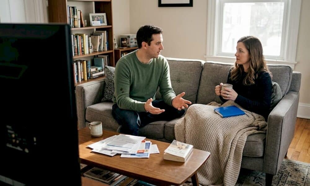 Couple talking calmly on living room couch