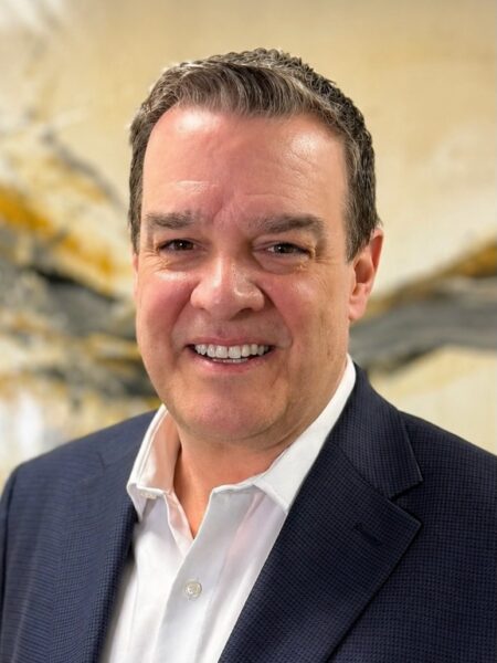 Matthew Brooks, LSW, smiling in professional attire against a textured background, representing Dr. Stephen Oreski & Associates psychotherapy team.