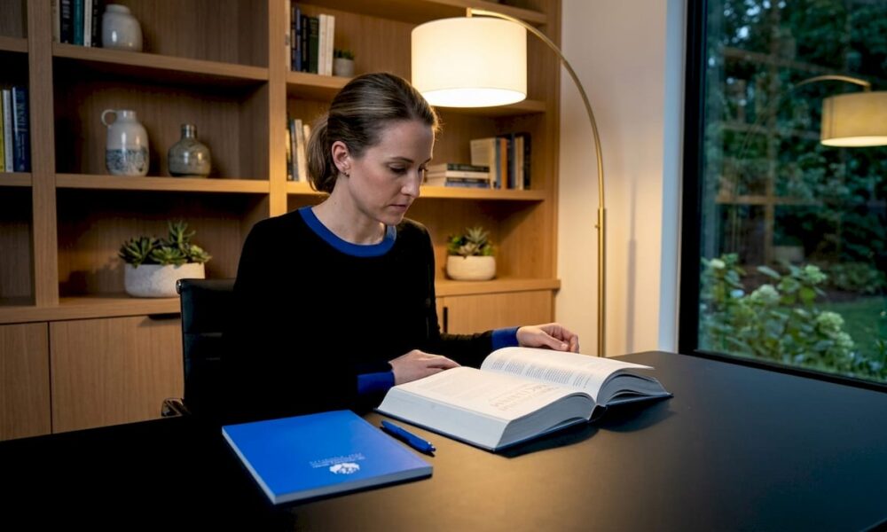 Woman reading psychology book at kitchen table