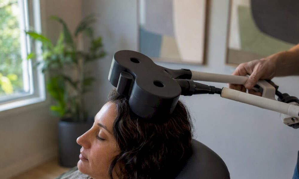 TMS therapy coil on patient scalp