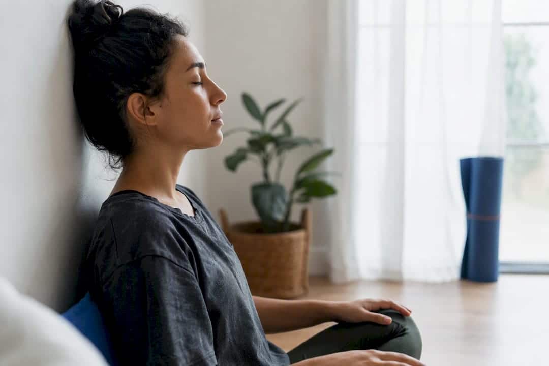 Person practicing breathing exercise in therapy room