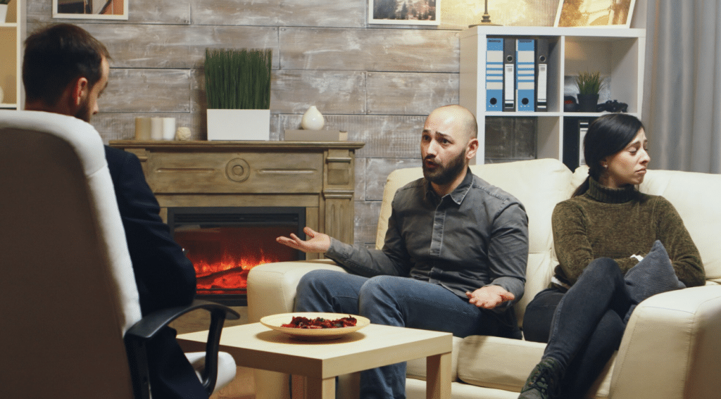 Upset couple talking with a therapist during a divorce therapy session in Paramus, New Jersey